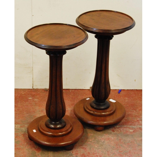 306 - Pair of Victorian mahogany stands, each with a saucer top above a fluted column and circular platfor... 