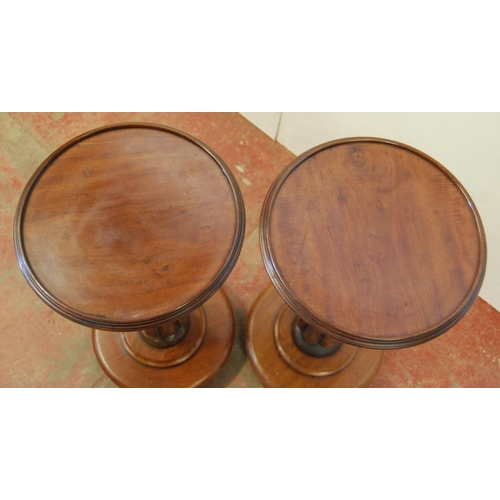 306 - Pair of Victorian mahogany stands, each with a saucer top above a fluted column and circular platfor... 