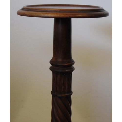 309 - Pair of mahogany torchères, c. early 20th century, each with a saucer top above turned reeded column... 