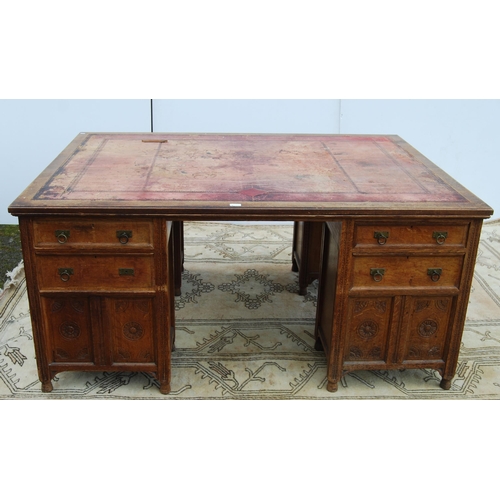 318 - Carved oak partner's desk, c. early 20th century, with tooled skiver above drawers and doors to both... 