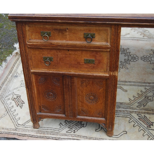 318 - Carved oak partner's desk, c. early 20th century, with tooled skiver above drawers and doors to both... 