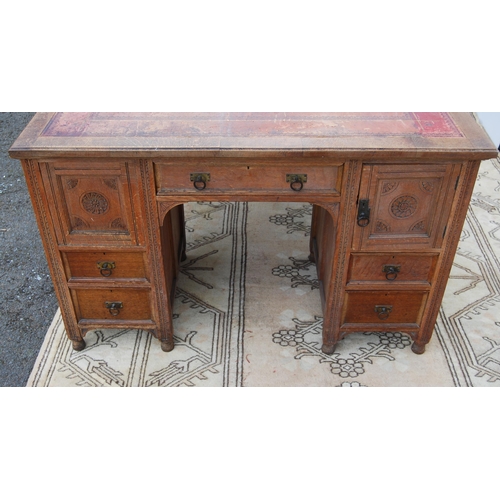 318 - Carved oak partner's desk, c. early 20th century, with tooled skiver above drawers and doors to both... 