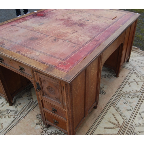 318 - Carved oak partner's desk, c. early 20th century, with tooled skiver above drawers and doors to both... 