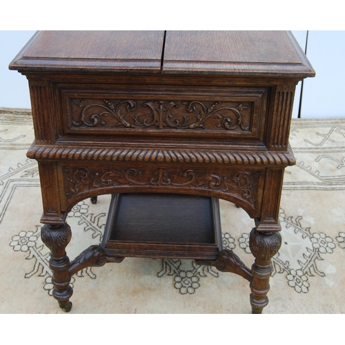 322 - Carved oak drinks cabinet by Maple & Co., with two divisions to the top opening to reveal a rise... 