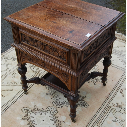 322 - Carved oak drinks cabinet by Maple & Co., with two divisions to the top opening to reveal a rise... 