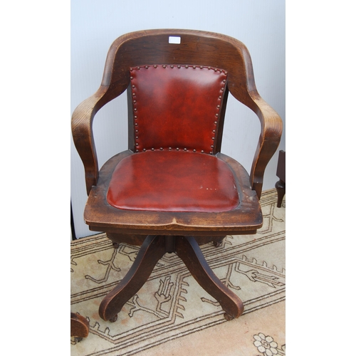 323 - Pair of early 20th century oak revolving captain's desk chairs upholstered in later Rexine, metal ad... 