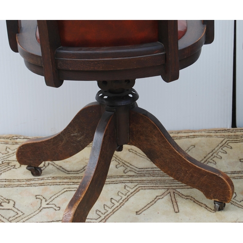 323 - Pair of early 20th century oak revolving captain's desk chairs upholstered in later Rexine, metal ad... 