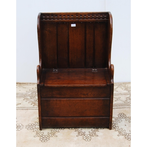 327 - Oak hall seat in the form of a settle with carved lunettes to the frieze above a panelled back and s... 