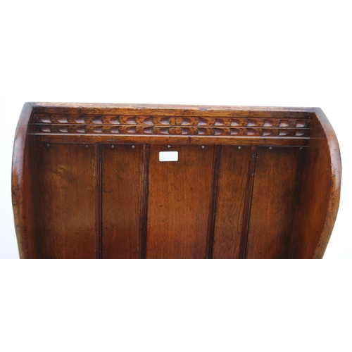 327 - Oak hall seat in the form of a settle with carved lunettes to the frieze above a panelled back and s... 