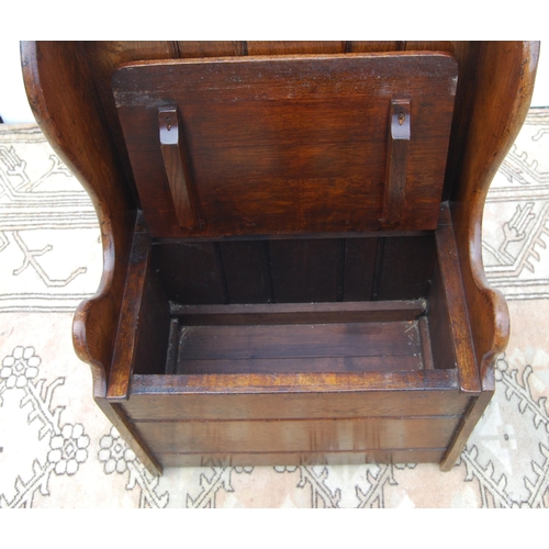 327 - Oak hall seat in the form of a settle with carved lunettes to the frieze above a panelled back and s... 