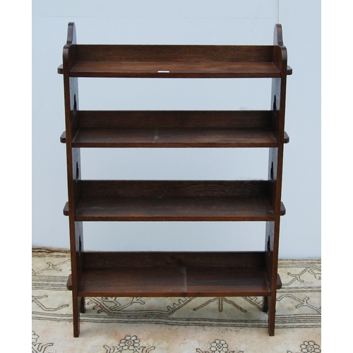 331 - Arts & Crafts oak open bookcase, c. 1930s, with peg-style joins and pierced clover roundels to e... 