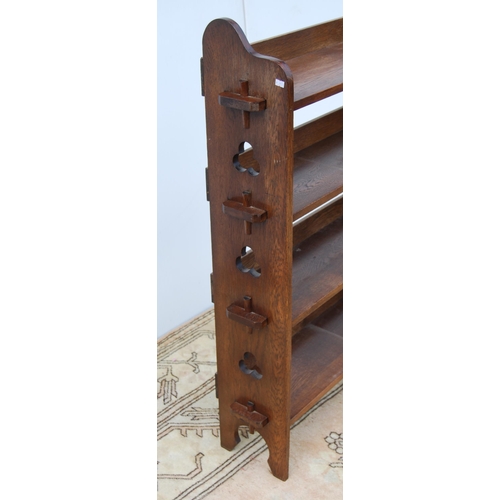 331 - Arts & Crafts oak open bookcase, c. 1930s, with peg-style joins and pierced clover roundels to e... 