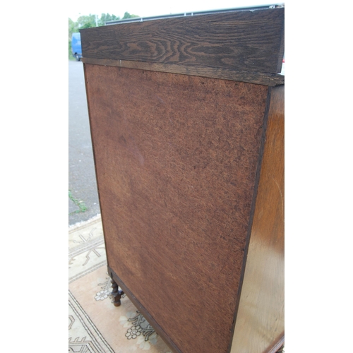 332 - Oak secrétaire bookcase with glazed bookcase section above a tambour roller shutter enclosing fitted... 