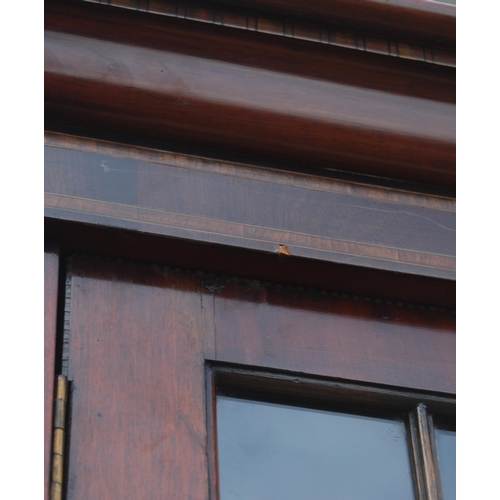 333 - Late Victorian / Edwardian inlaid mahogany library bookcase, the shaped dentil cornice above three a... 