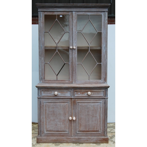 334 - Stained wood bookcase by Maple & Co., with two astragal glazed doors enclosing a shelved interio... 