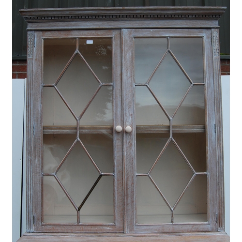 334 - Stained wood bookcase by Maple & Co., with two astragal glazed doors enclosing a shelved interio... 