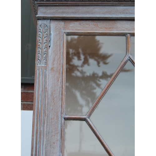 334 - Stained wood bookcase by Maple & Co., with two astragal glazed doors enclosing a shelved interio... 