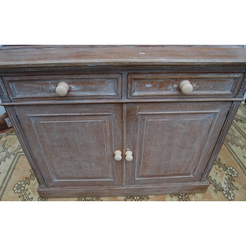 334 - Stained wood bookcase by Maple & Co., with two astragal glazed doors enclosing a shelved interio... 