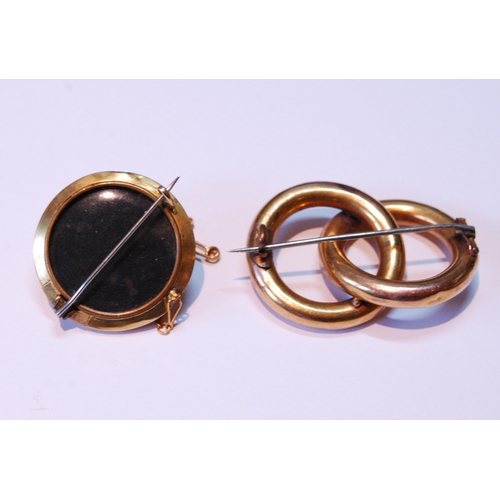 22 - Gold tubular brooch with entwined hoops and a gold boss brooch.