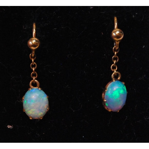 27 - Pair of opal drop earrings, each oval opal dependant from a bead.