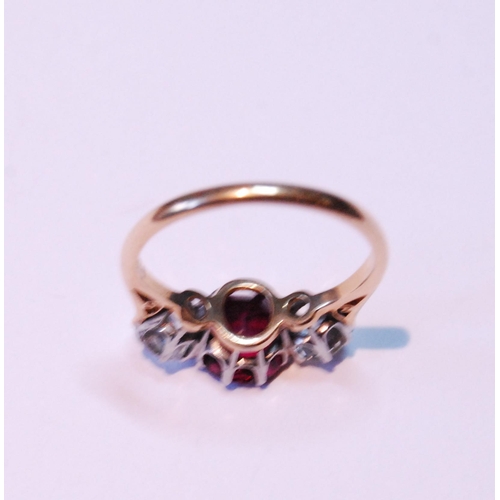 3 - Three-stone ruby and diamond ring, the almost-circular ruby approximately 6mm x 7mm, with two old-cu... 