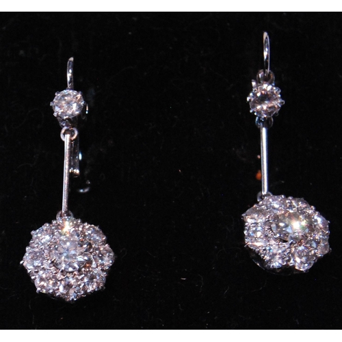 4 - Pair of diamond drop earrings, each with a cluster of nine-old cut brilliants dependant from another... 