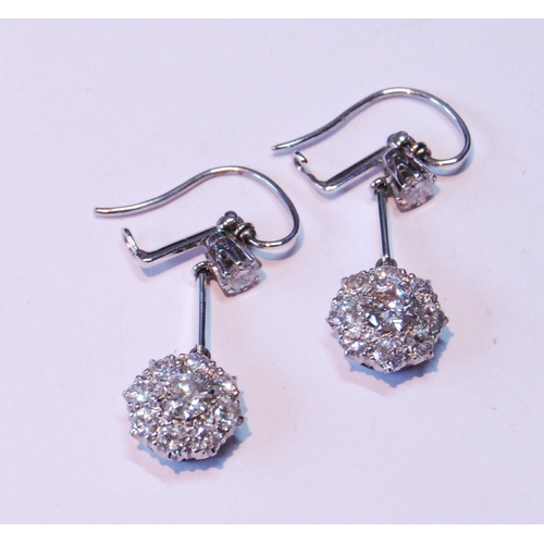 4 - Pair of diamond drop earrings, each with a cluster of nine-old cut brilliants dependant from another... 