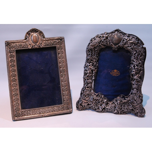 90 - Silver photograph frame pierced with putti and scrolls, by W Comyns, 1895, 22cm x 17cm, and another.... 