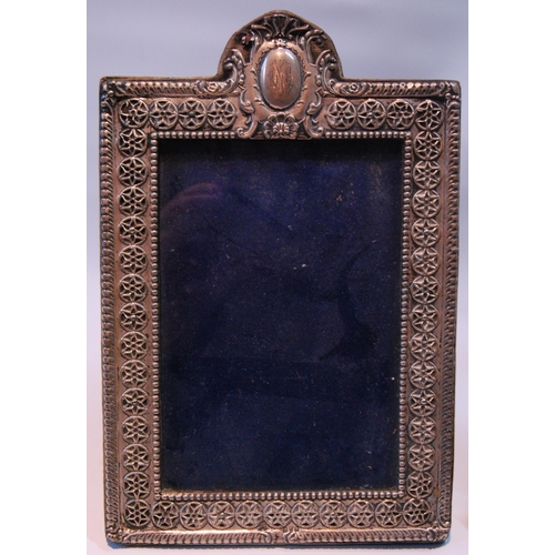 90 - Silver photograph frame pierced with putti and scrolls, by W Comyns, 1895, 22cm x 17cm, and another.... 