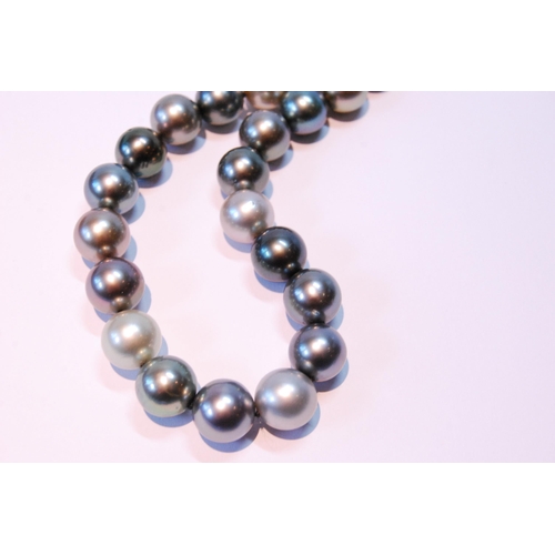 47 - Black and tinted pearl necklet on diamond-set gold ball snap, '750', by JKa Koehle.