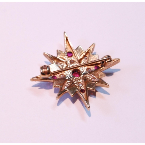 51 - Small diamond and ruby star brooch in 9ct gold, 1966, 4g gross.