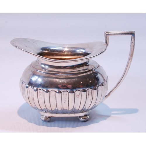 93 - Silver cream jug of gadrooned ovoid shape by Walker & Hall, Sheffield 1897, 152g or 5oz.