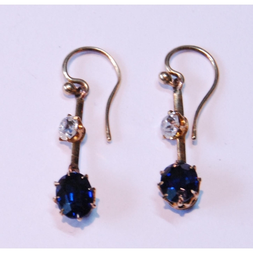 7 - Pair of drop earrings, each with oval sapphire dependant from a diamond collet on knife edge.