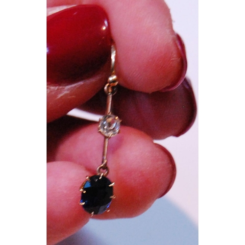 7 - Pair of drop earrings, each with oval sapphire dependant from a diamond collet on knife edge.