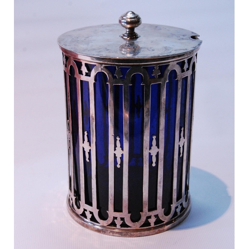 97 - Silver pickle or preserve jar pierced with arcading, with blue glass liner and cover, by the Goldsmi... 