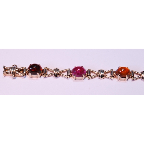 63 - 9ct gold bracelet with cabochon garnet, citrine, amethyst and other gems, 15.5g gross.