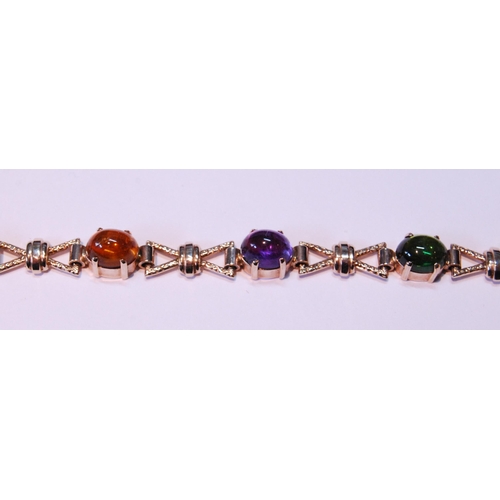 63 - 9ct gold bracelet with cabochon garnet, citrine, amethyst and other gems, 15.5g gross.