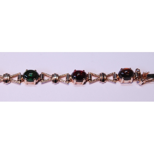 63 - 9ct gold bracelet with cabochon garnet, citrine, amethyst and other gems, 15.5g gross.