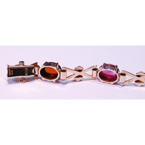 63 - 9ct gold bracelet with cabochon garnet, citrine, amethyst and other gems, 15.5g gross.