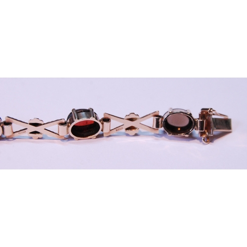 63 - 9ct gold bracelet with cabochon garnet, citrine, amethyst and other gems, 15.5g gross.