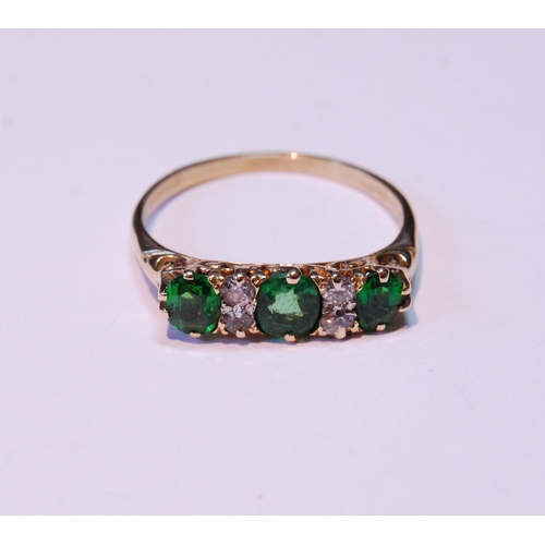 67 - Demantoid garnet three-stone ring with four diamond brilliants, '18ct' (uncertificated), size S.