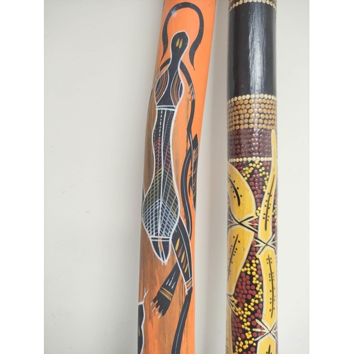 287 - Two wooden didgeridoos, each painted with aboriginal motifs. (2)