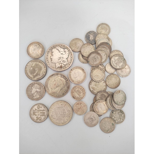 178 - Silver world coins to include an 1883 U.S morgan dollar, a 1936 Southern Rhodesia shilling, and a qu... 