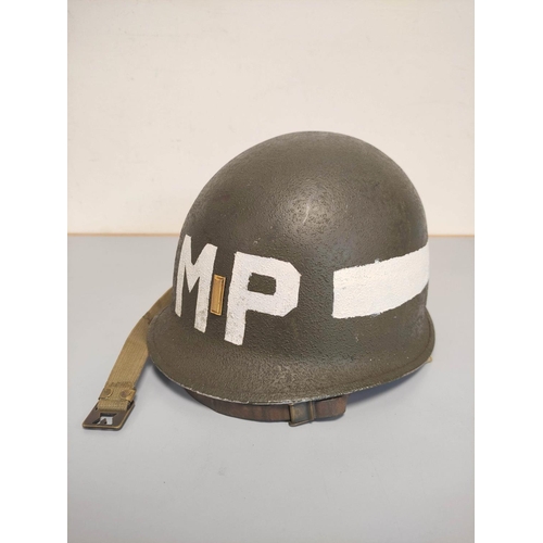 210 - USA WW2 era M1 helmet with military police markings c1944. Original olive green textured painting an... 