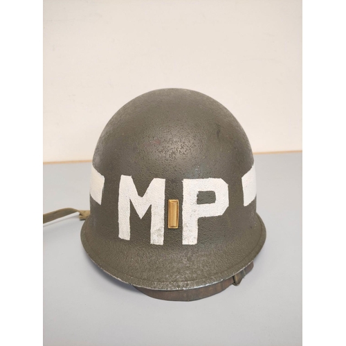 210 - USA WW2 era M1 helmet with military police markings c1944. Original olive green textured painting an... 