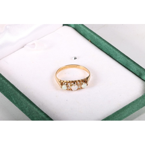 150 - 18ct gold dress ring with three graduated opals separated by chip diamonds, hallmarked, size Q/R, 3.... 