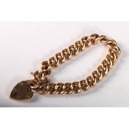 186 - 9ct gold curb link bracelet and heart padlock, 21.3 g. 