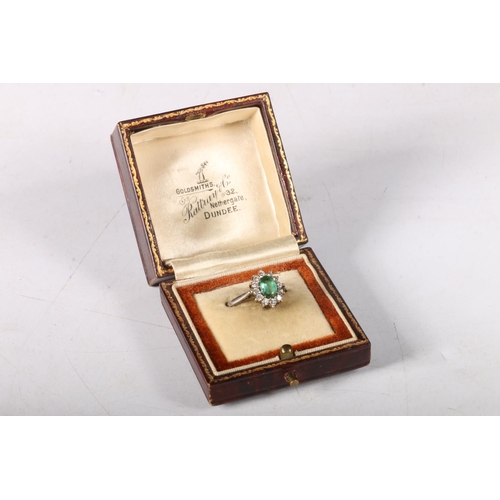 196 - 18ct white gold cluster ring with oval cut green stone encircled by diamonds, size K/L, 3.8g. 