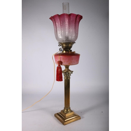 391 - Youngs brass oil lamp circa early 20th century with later tinted glass shade and funnel above opaque... 