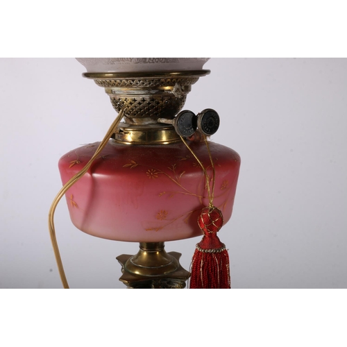 391 - Youngs brass oil lamp circa early 20th century with later tinted glass shade and funnel above opaque... 